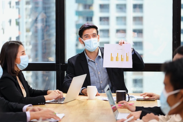 executive-team-meeting-during-coronavirus-or-covid-19-for-business-new-financial-strategy-after-pandemic-with-all-staff-members-wearing-facial-mask-as-of-new-normal-and-social-distancing-policy