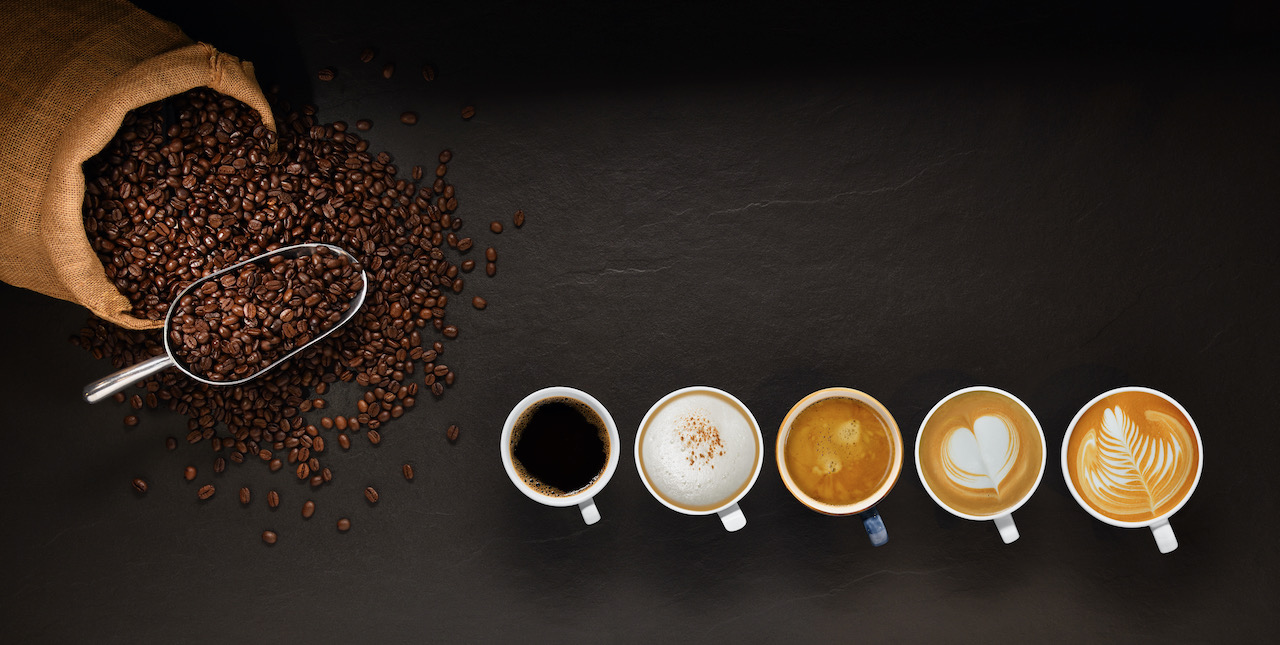 variety-of-cups-of-coffee-and-coffee-beans-in-burlap-sack-on-black-background