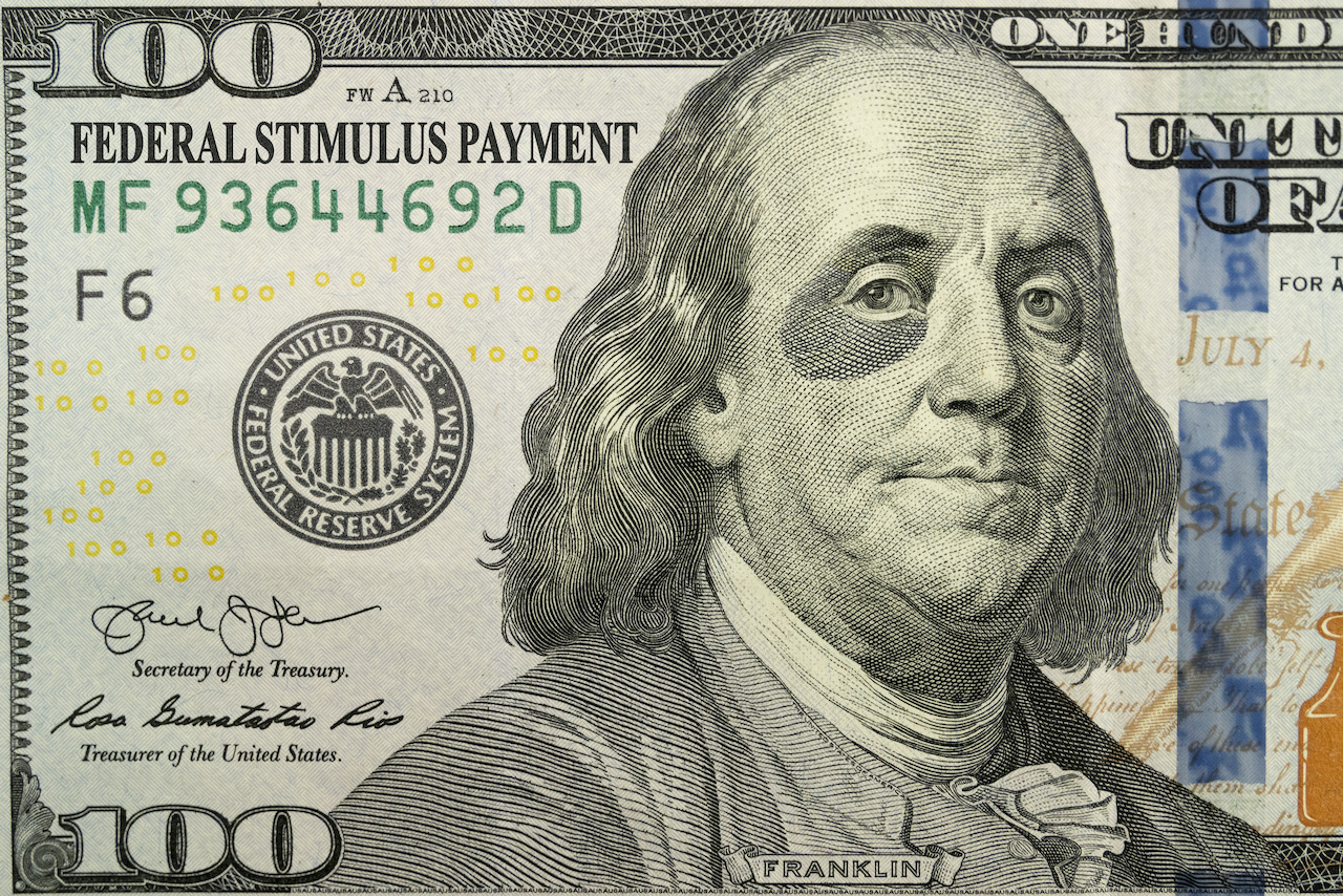 this-brand-new-one-hundred-bill-and-ben-franklin-with-a-black-eye-tell-an-economic-story.-the-added-text-of-federal-stimulus-payment-explains-the-economic-support